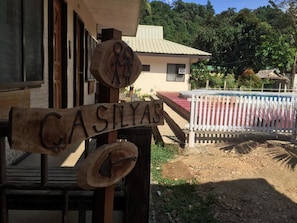A wooden sign with the name "CASILYAS" and a circular emblem with two figures. - Tay LeLong's Pension House (Taytay)
