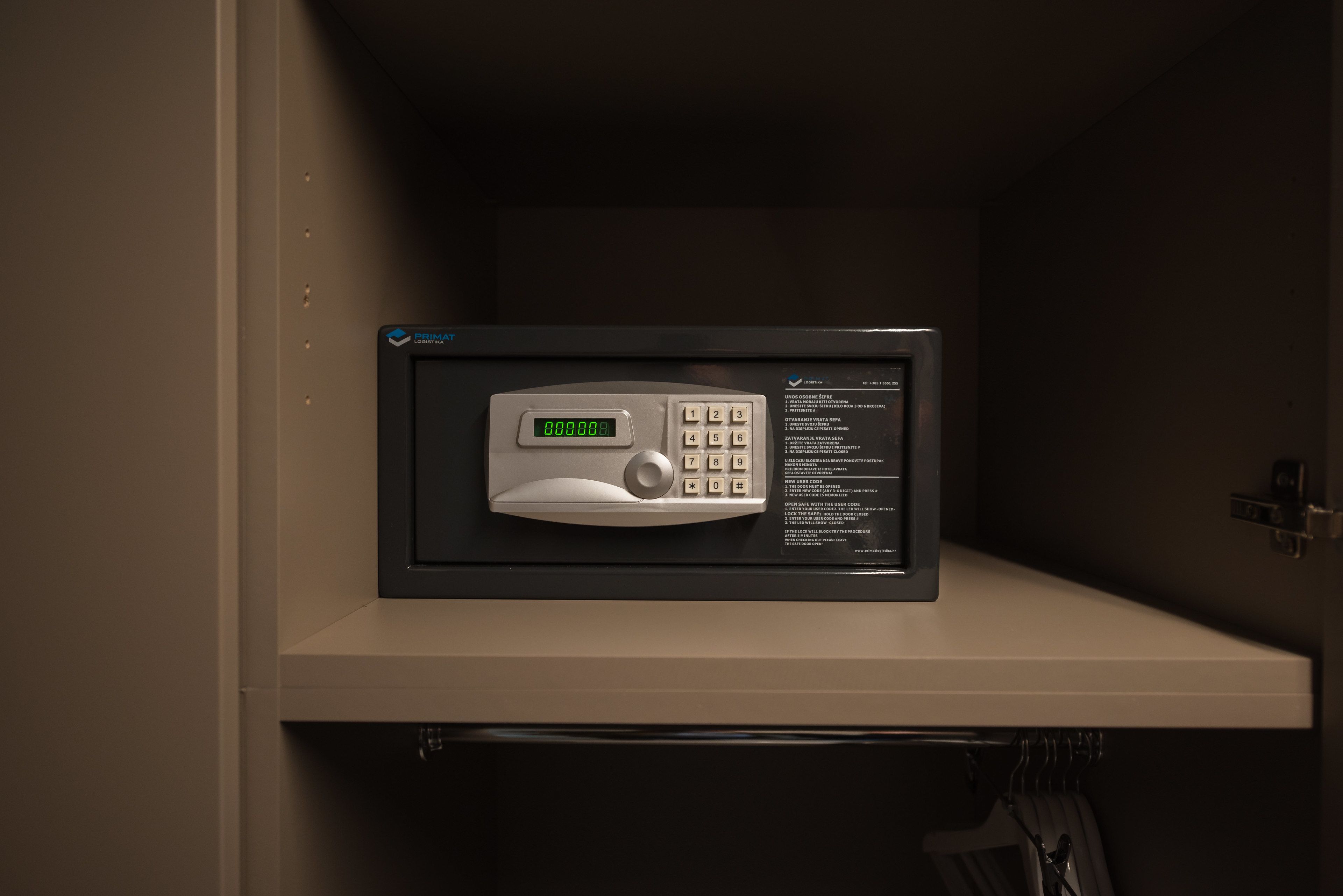 A microwave with a digital display and keypad, housed in a cabinet.