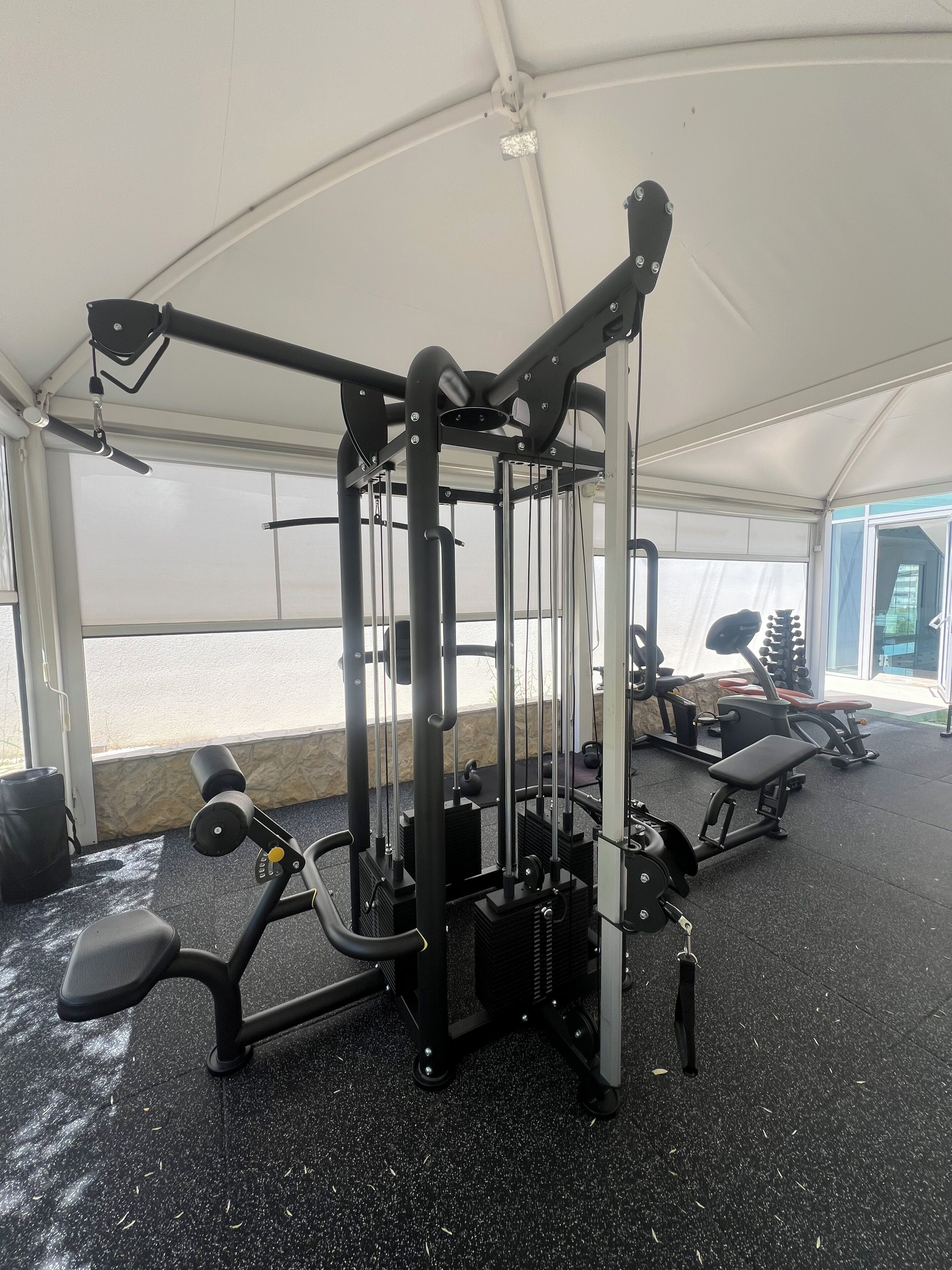 A gym with exercise equipment, a ceiling fan, and a view of the outside.