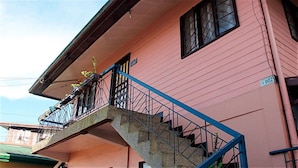 A pink building with a balcony and a staircase. - Sweet Star Transient Home (Baguio)