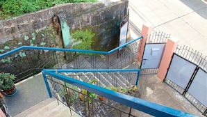 A staircase with blue railings leading to a gated area. - Sweet Star Transient Home (Baguio)