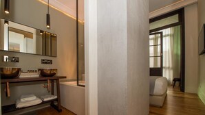 A modern bathroom with a large mirror, two copper sinks, and a wooden vanity. - Hotel Boutique Loriente (Ribadeo)