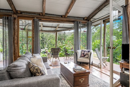 Romantic Cabin, 1 Bedroom, Bathtub, Garden View | Living area | Flat-screen TV, DVD player