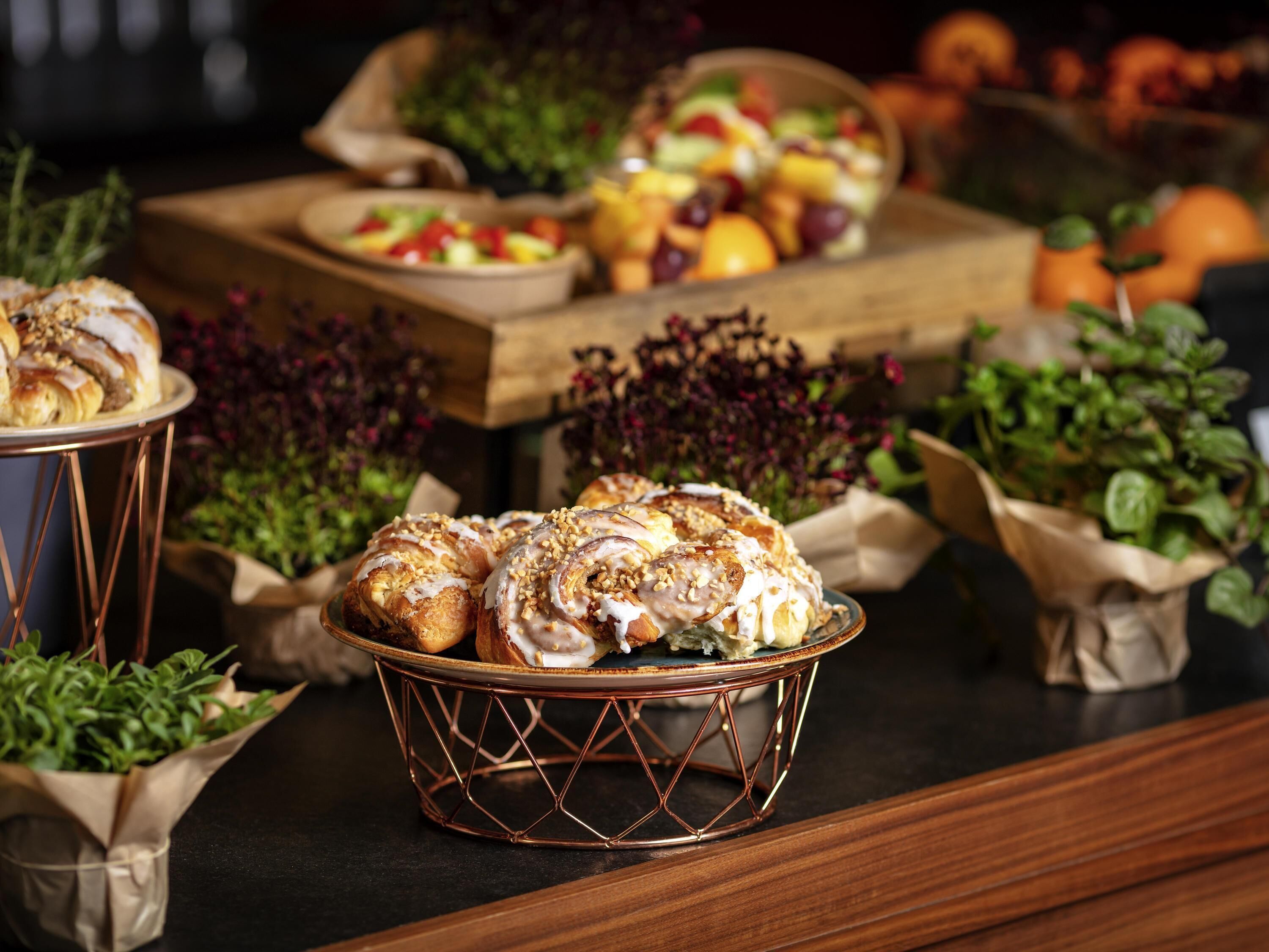 A buffet table with various food items and a decorative centerpiece.