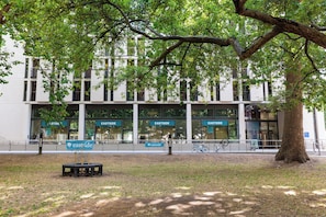 A building with multiple 'EASTSIDE' signs, a bench, and a bicycle.