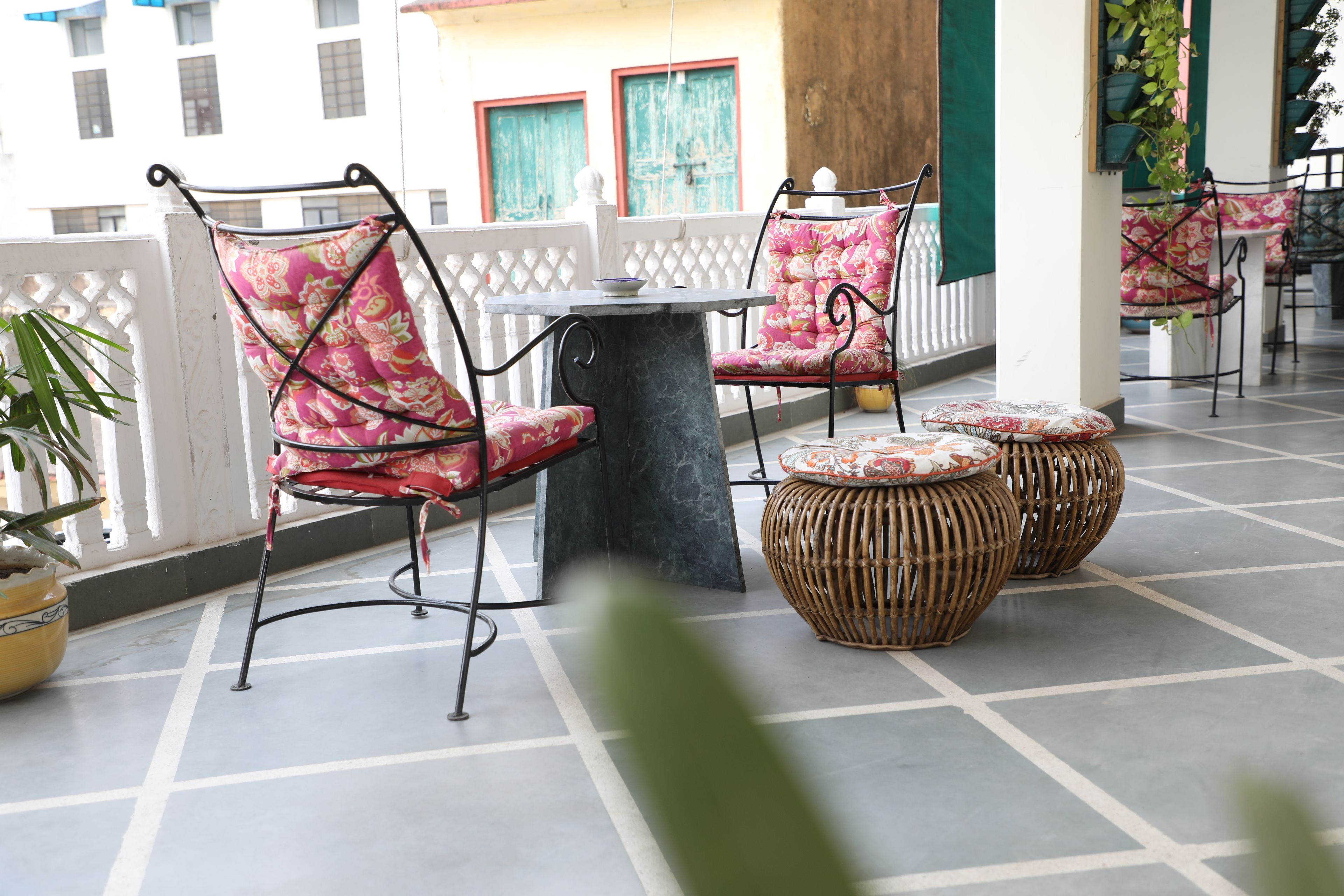 A terrace with wicker furniture and a tiled floor.