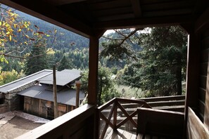 A wooden deck with a view of a mountainous landscape.