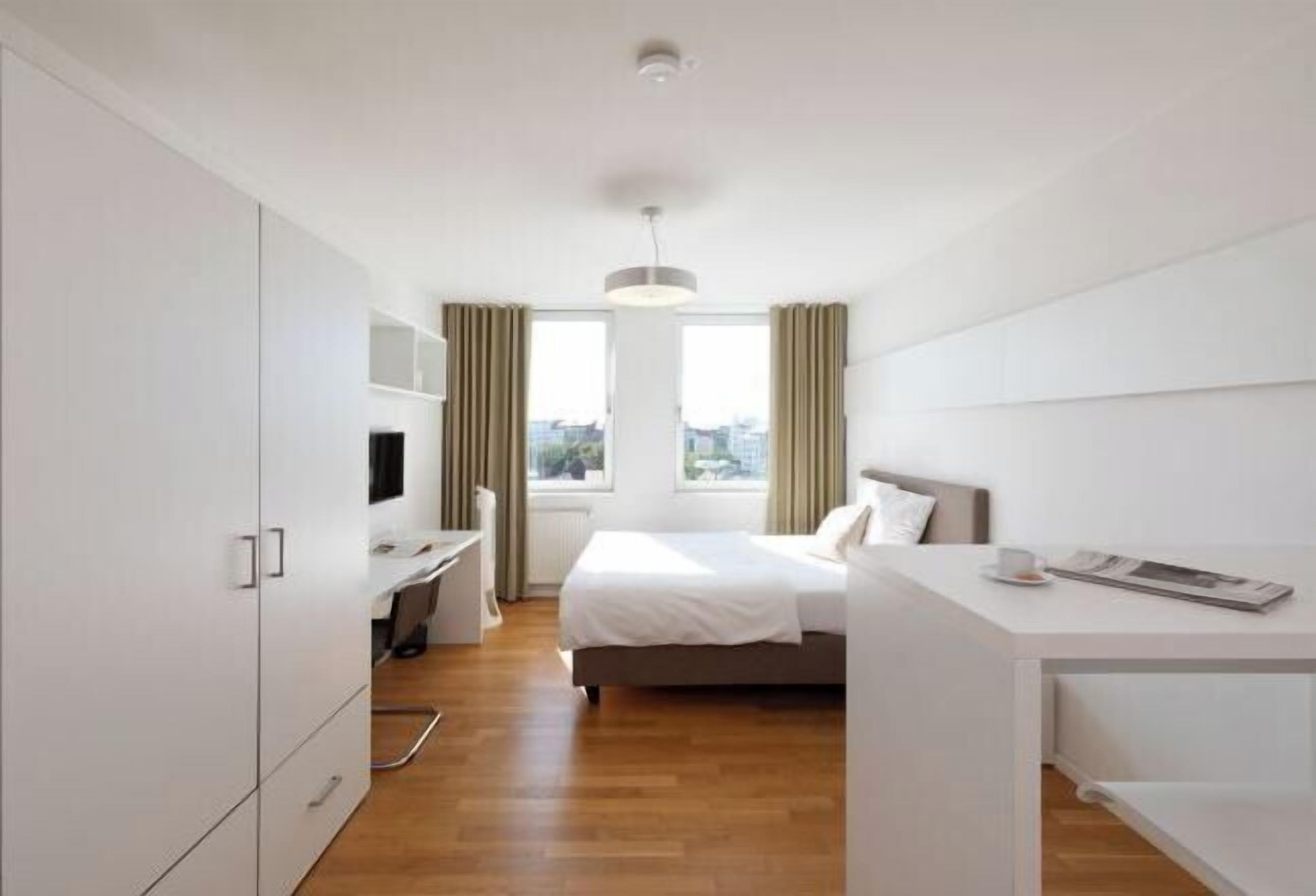 Premium bedding, desk, laptop workspace, blackout curtains