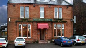 A brick building with a sign reading "Anerdour Hotel". There are cars parked in front. - Aberdour Guest House (Dumfries)