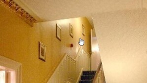 A grand staircase with ornate railings and carpeted steps leading to a landing. - Aberdour Guest House (Dumfries)