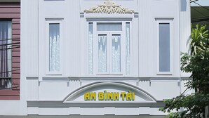A hotel facade with a classic architectural design, featuring a prominent entrance with a sign reading "KHÁCH SAN HOTEL AN BÌNH TÁI". - An Binh Tai Hotel (Da Nang)