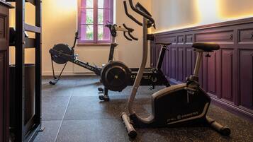 Une salle de sport à domicile équipée de vélos d’appartement et d’un appareil d’entraînement elliptique.