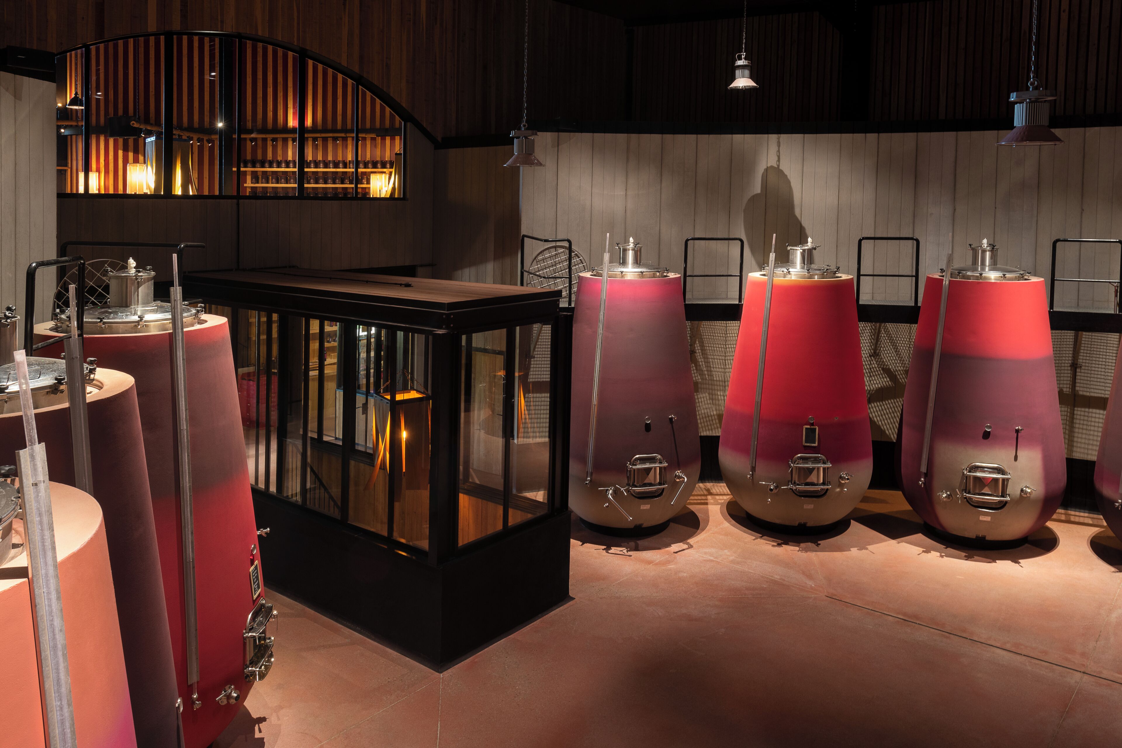 A bar area with a counter, stools, and a large red cylindrical object.