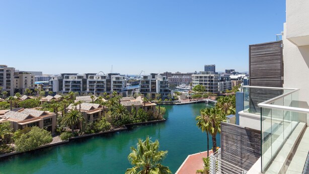A high-rise building with a view of a marina and surrounding buildings. - 606 Juliette B (Cape Town)