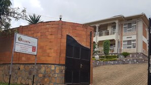 A building with a sign for 'Mubale Courts' and 'Kigali Vocation Training Center'. - Mubwiza Courts (Kigali)