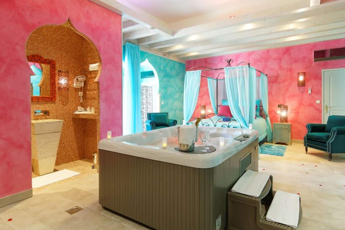 A modern bathroom with a large bathtub, a vanity, and a shower area.