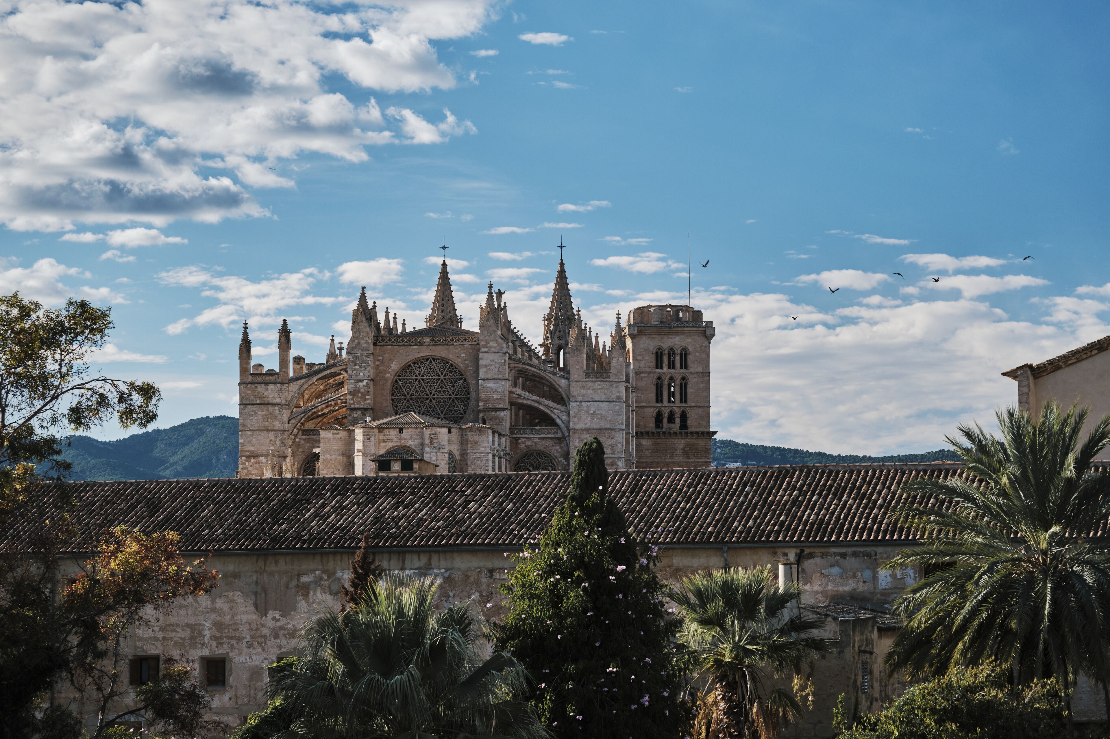 A historic cathedral with multiple spires and a large central rose window.