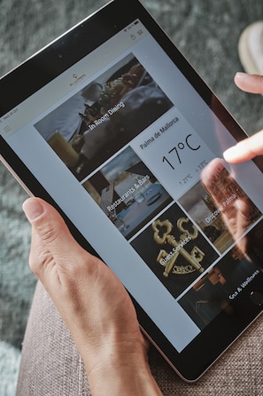 A tablet displaying a hotel booking interface with options for room dining, restaurants, and wellness services. - Hotel El Llorenç Parc de la Mar - Adults Only (Palma de Mallorca)