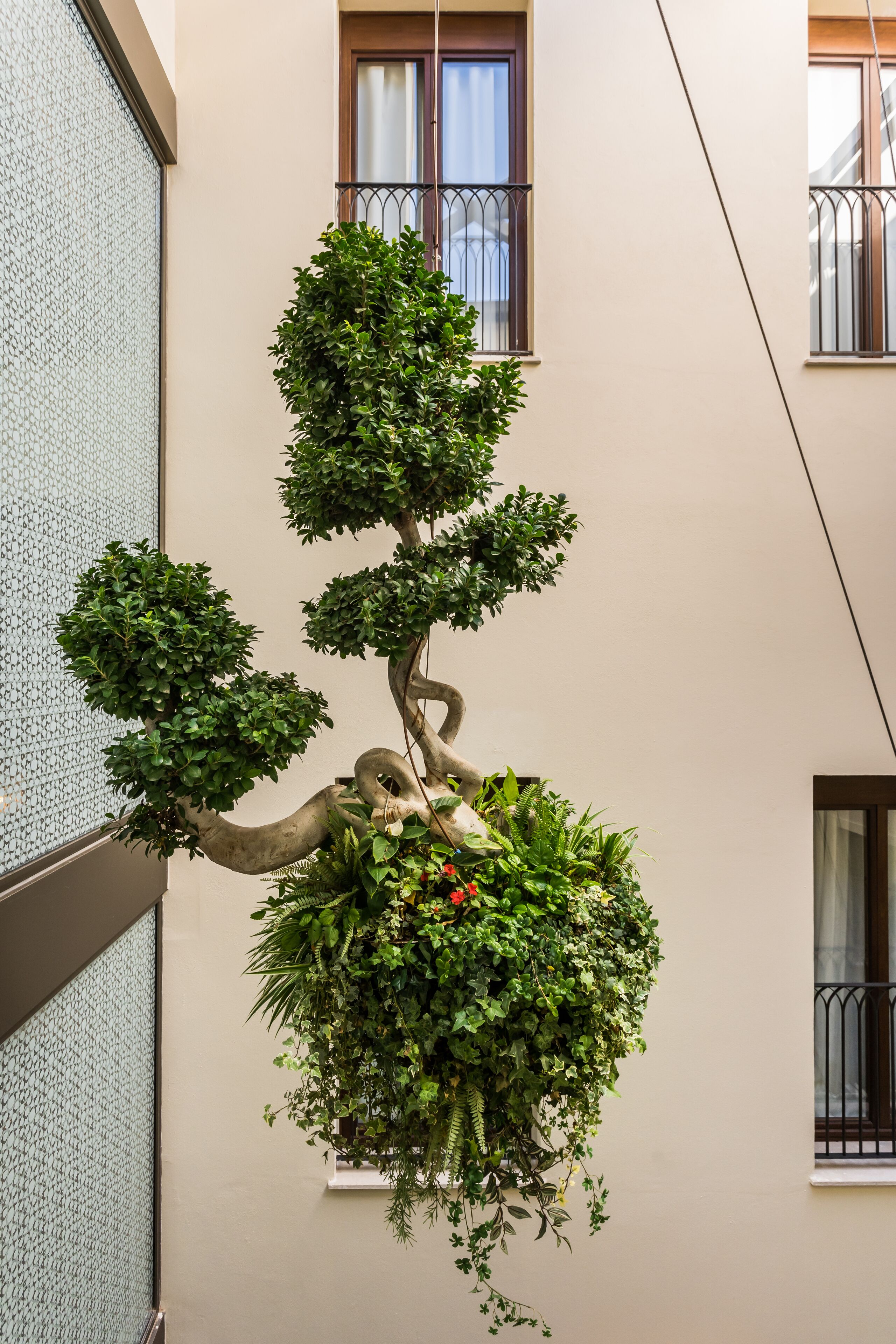 A building with a balcony and a hanging garden.