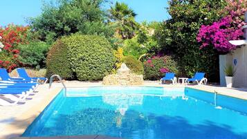 Seasonal outdoor pool, open 10 AM to 7:00 PM, pool umbrellas