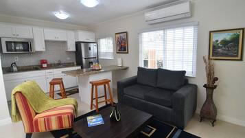 Executive Villa, 1 Bedroom, Garden View | Living room | 50-inch flat-screen TV with cable channels, TV, DVD player