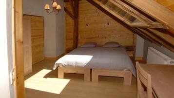 A bedroom with a wooden bed, a nightstand, and a dresser.