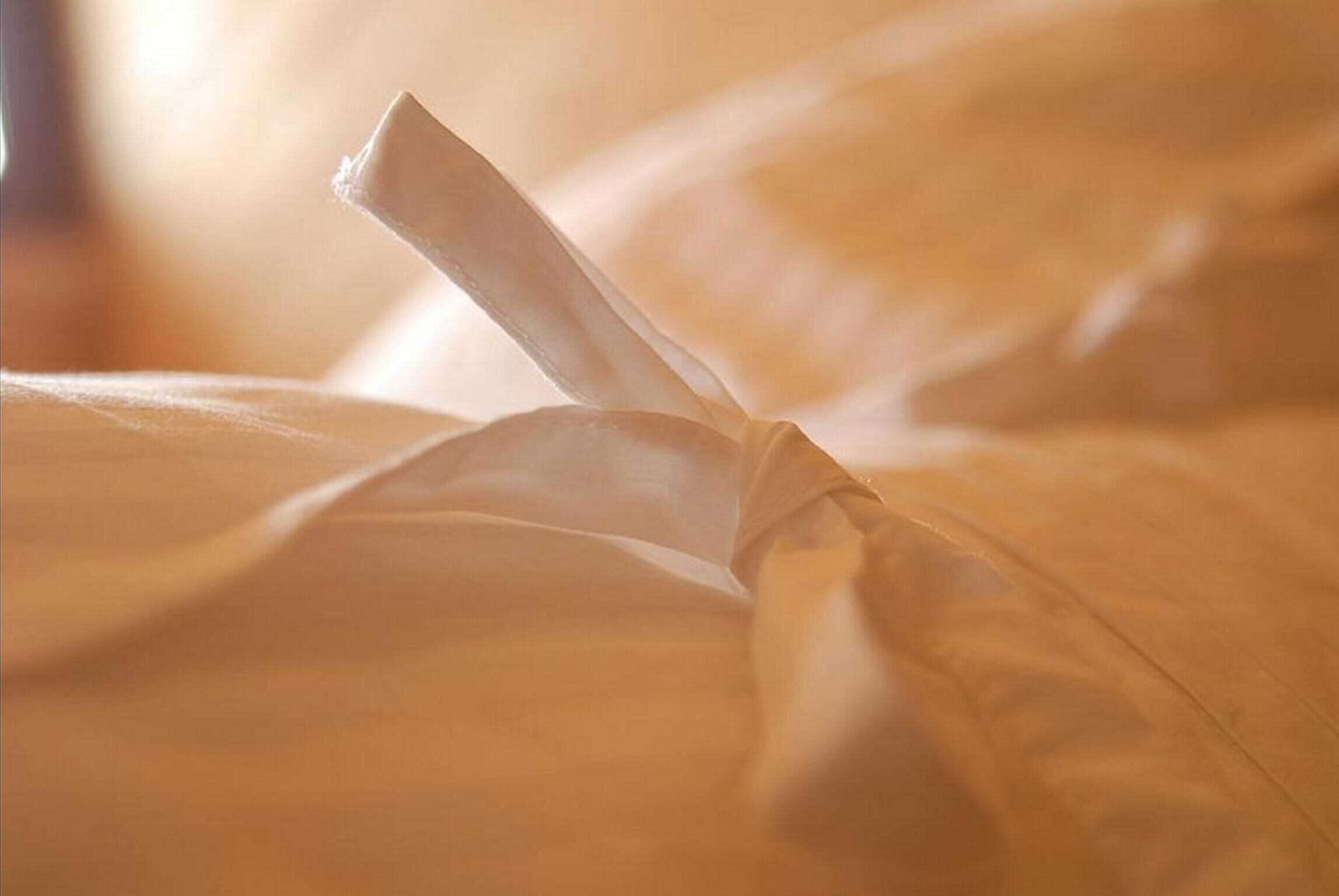 A neatly made bed with a folded blanket.