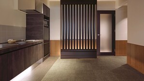 Una cocina moderna con armarios oscuros, una campana extractora de acero inoxidable y una encimera de madera.