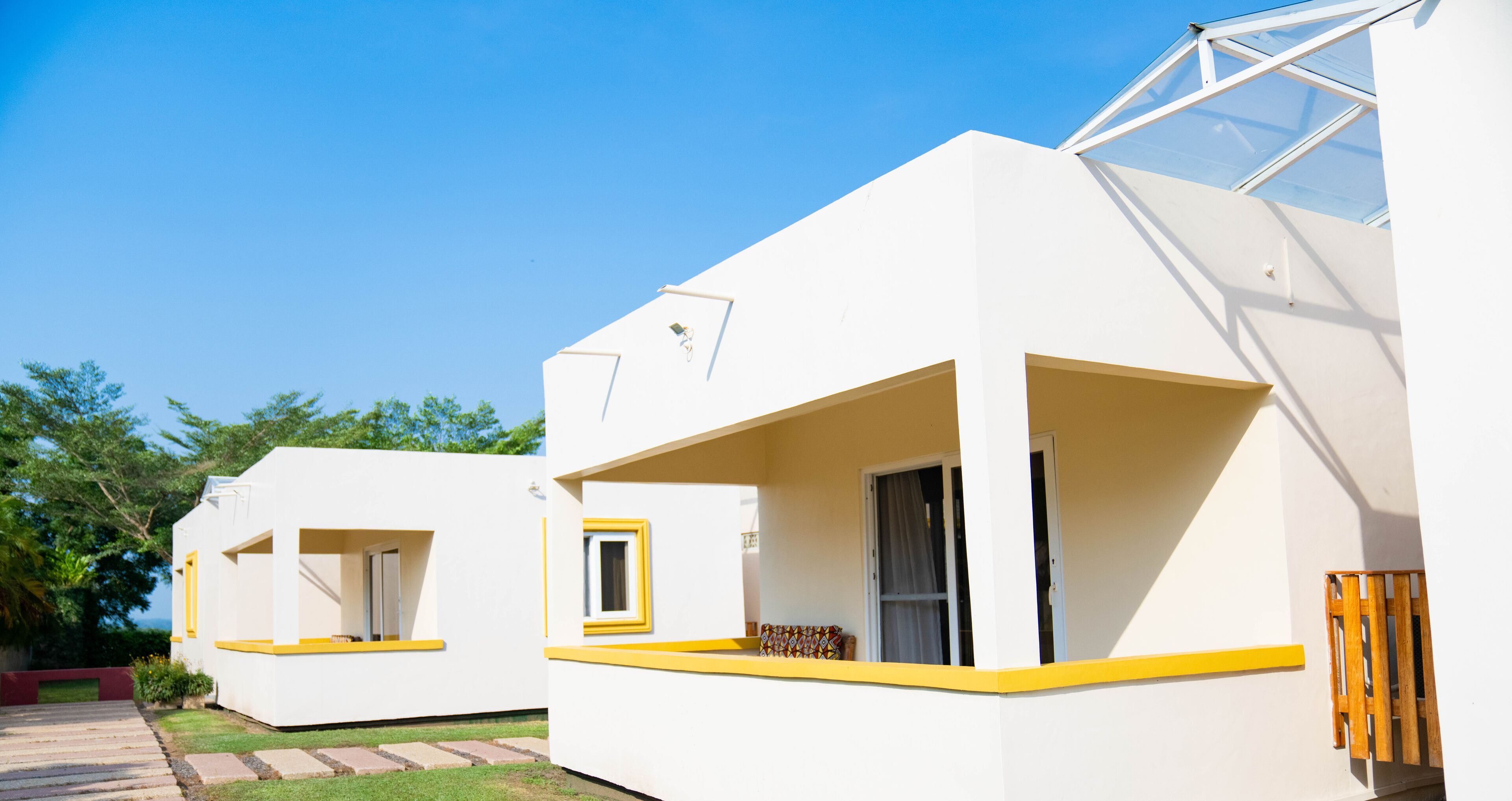 A modern, white building with yellow trim and large windows.