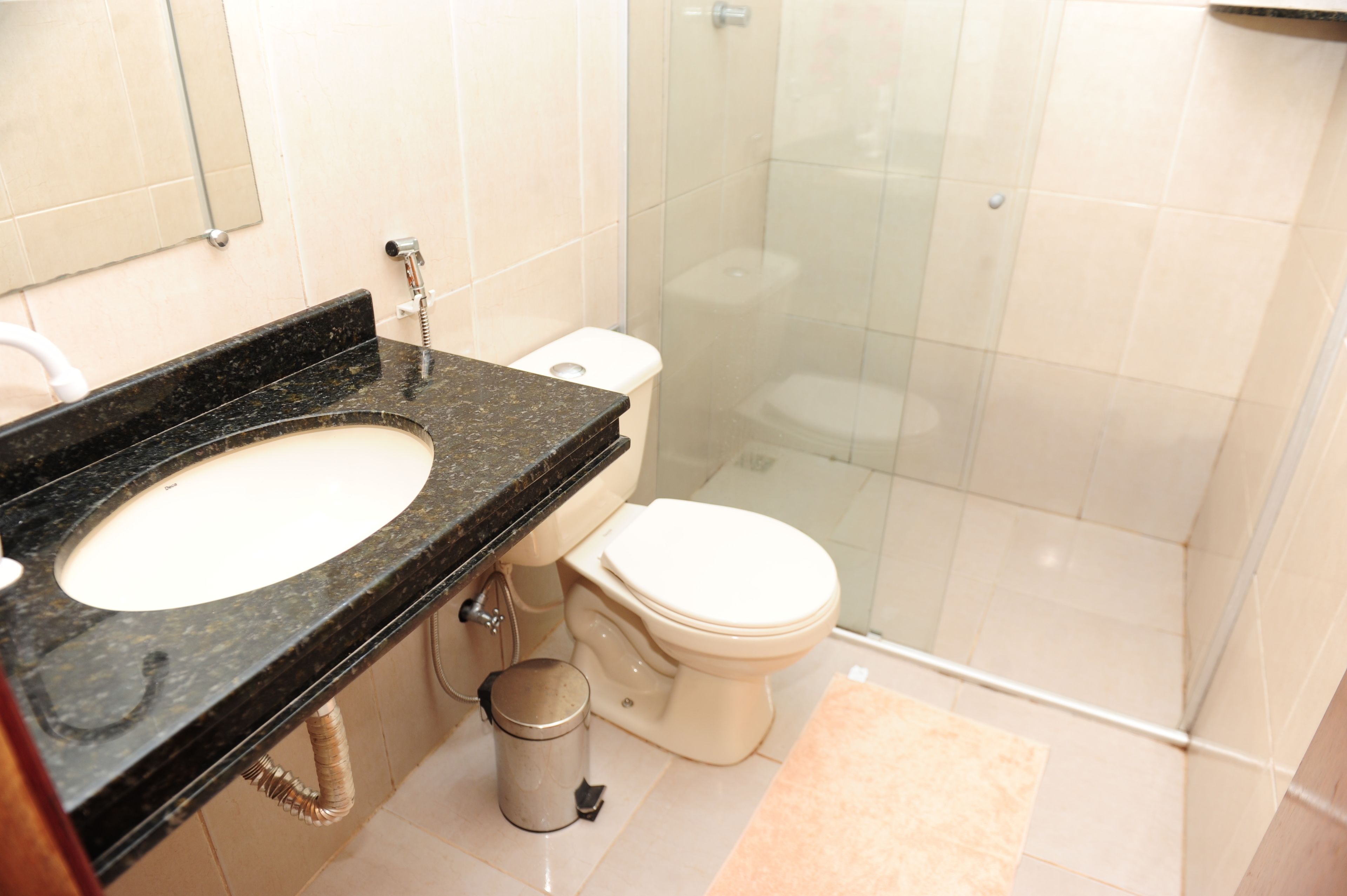A bathroom with a sink, toilet, and shower.