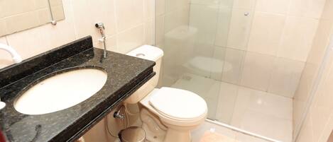 A bathroom with a sink, toilet, and shower.