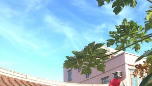 A traditional building with a tiled roof and brick walls, a small outdoor seating area with a table and chairs, and a large tree with green leaves in the foreground. - Kinmen RuJia B&B (Jincheng)