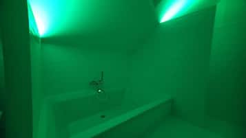 A bathroom with a bathtub, a shower, and a toilet.