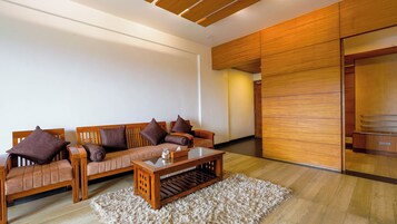 A modern living room with a sofa set, a coffee table, and a fluffy rug.