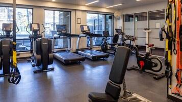 A gym with treadmills, stationary bikes, and weight machines.