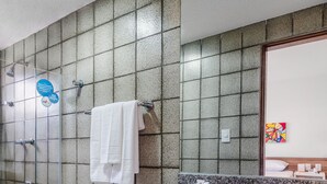 A bathroom with a toilet, sink, and shower.