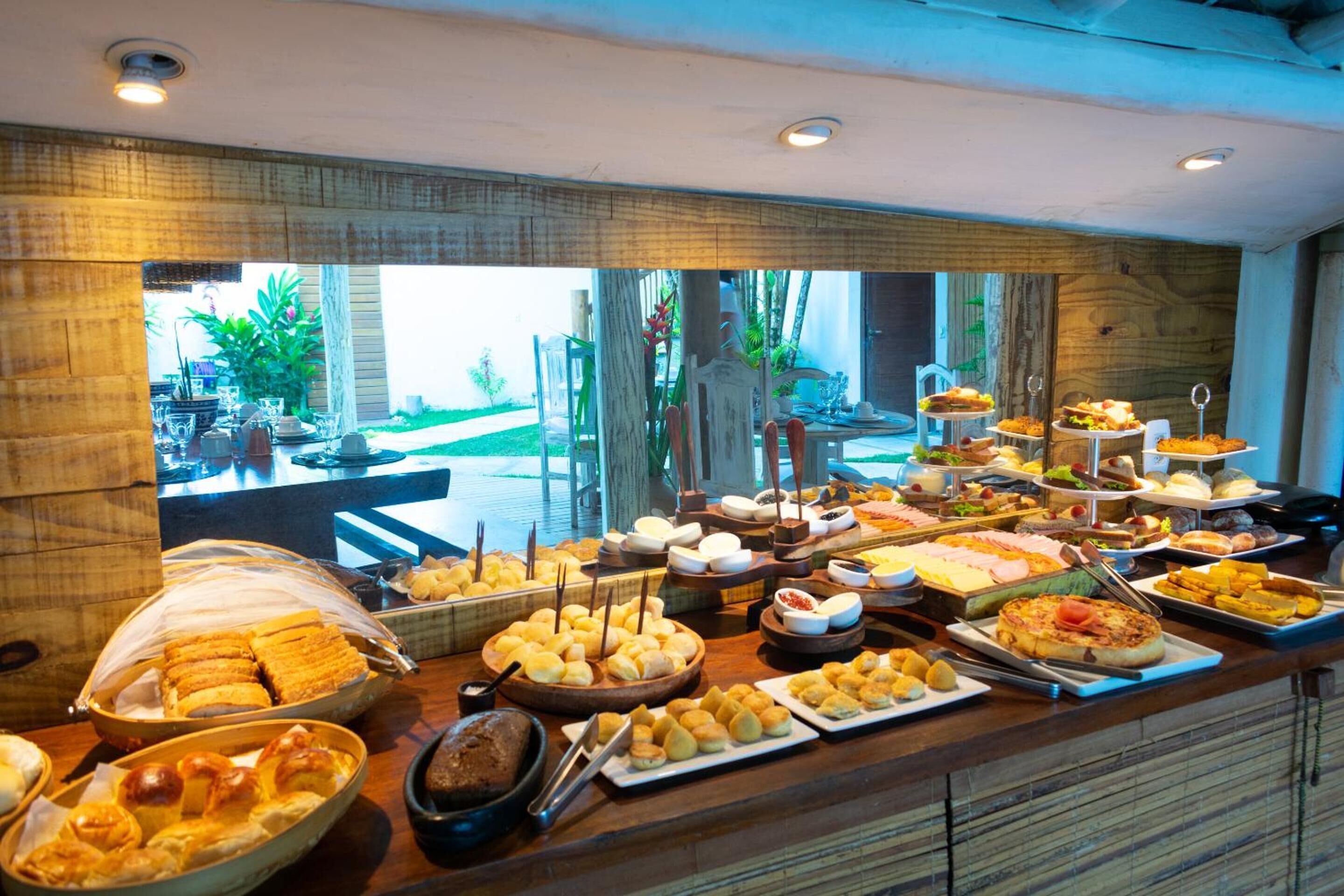 A buffet with various food items and a view of the outdoor area.