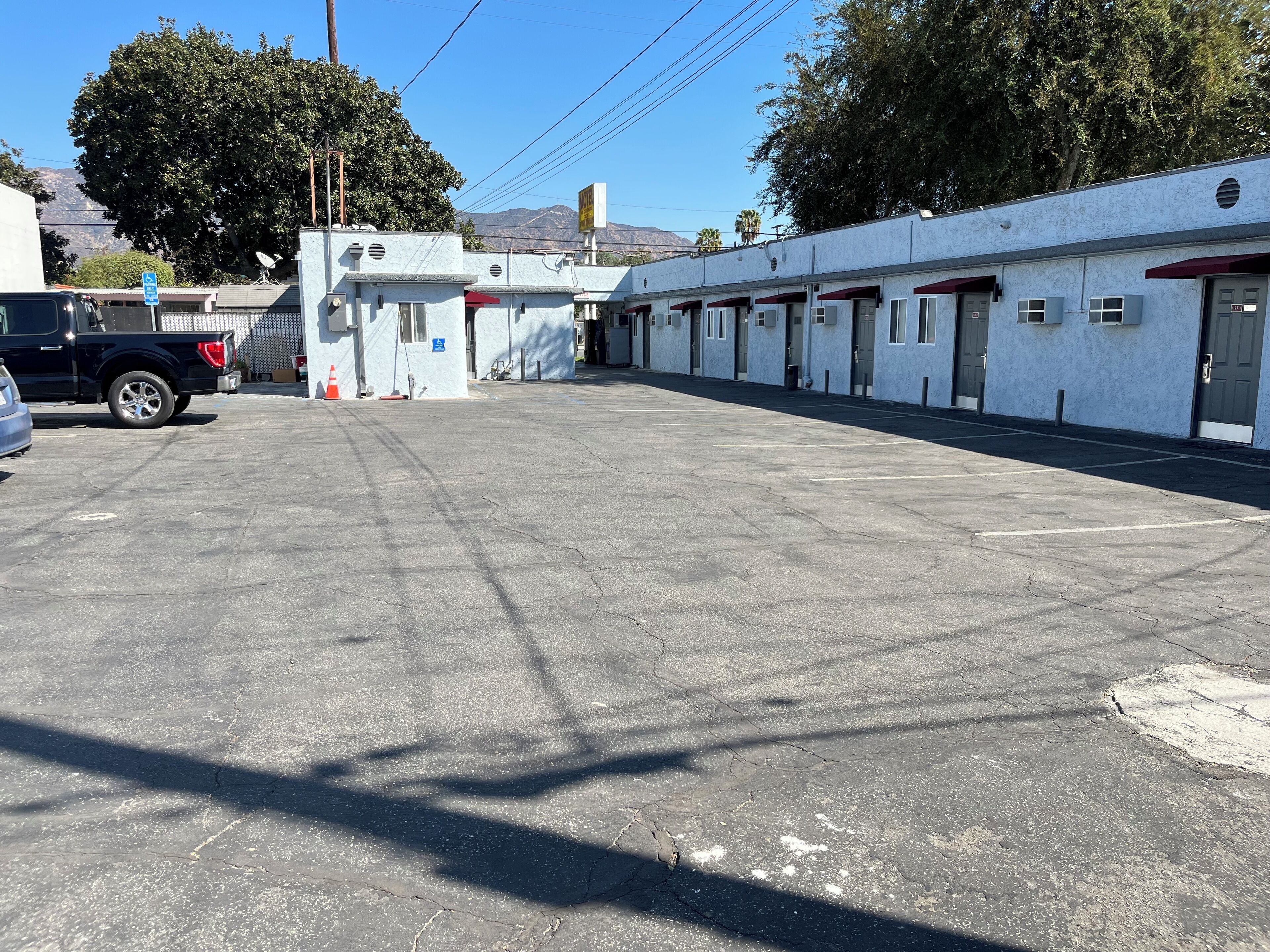 A parking lot with a row of fire stations and a truck.