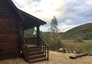 A wooden cabin with a porch and steps leading to a picnic table. - Fly Fishing in the Driftless Region - Bishop Creek Cabin with a View (Viroqua)