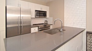 A modern kitchen with stainless steel appliances, a microwave, and a built-in oven.