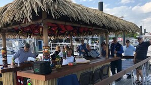 A thatched-roof outdoor bar area with a wooden counter, surrounded by a railing. - Mystic Home perfect for families- Easy walk to downtown. . (Mystic)