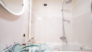 A bathroom with a glass-enclosed sink, a bathtub, a shower, and a white radiator. - Ca' Del Monastero 1 Collection with Balcony (Venice)