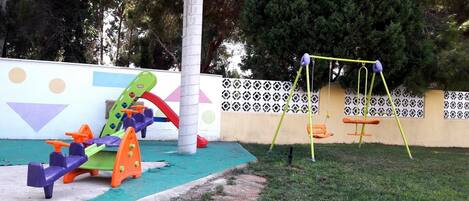 A playground with a swing set and colorful play equipment.