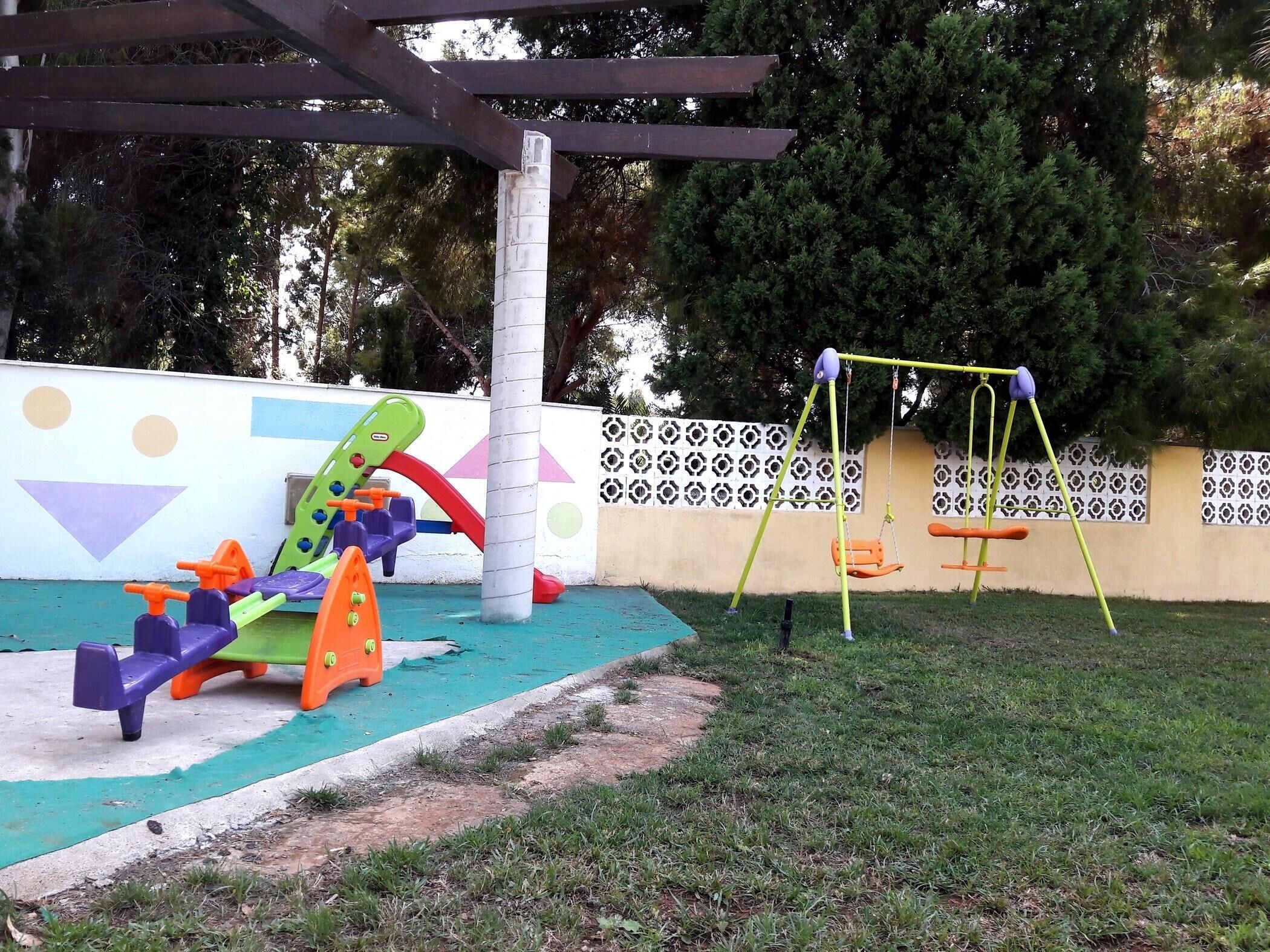 A playground with a swing set and colorful play equipment.