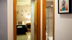 A hotel room with a bed, a nightstand, a lamp, and a framed picture on the wall. - Obelisc-3, 3 DB ground-floor apartment near the beach. (Can Picafort)