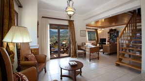 A spacious living area with a wooden staircase, a desk, and a view of the outdoors. - Luxury villa overlooking the sea with private pool-Villa Rose (Lefkada)