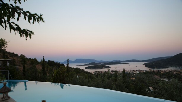 A infinity pool overlooking a scenic landscape with hills and a body of water. - Luxury villa overlooking the sea with private pool-Villa Rose (Lefkada)
