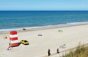 Enjoy a serene beach experience with a lifeguard tower and open spaces.