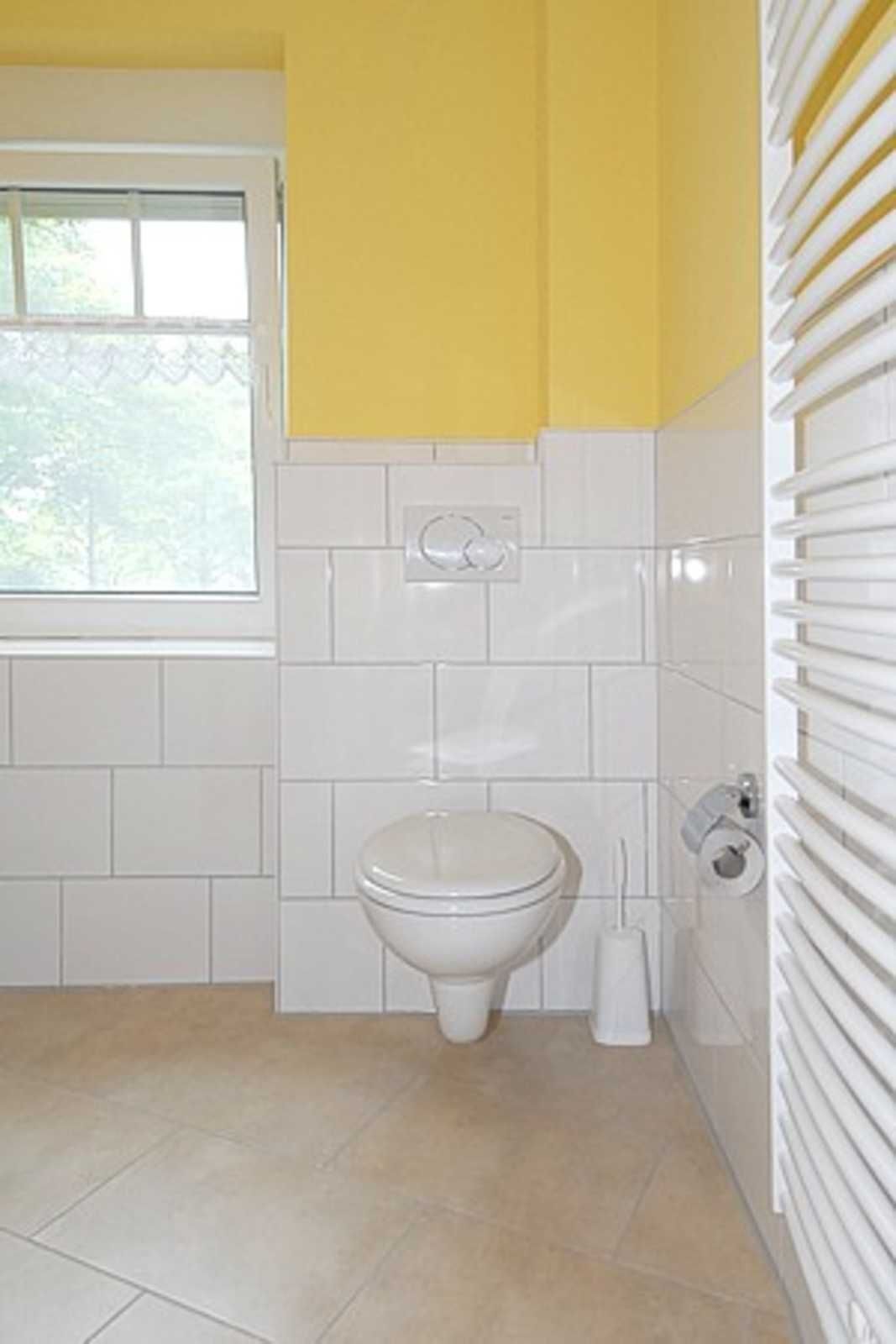 Ein Badezimmer mit Toilette, Bidet und Fenster.