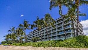 A multi-story hotel with balconies, located on a beach with palm trees. - Stunning Views & Tropical Tranquility 429 LS (Lahaina)